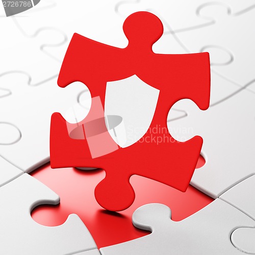 Image of Security concept: Shield on puzzle background
