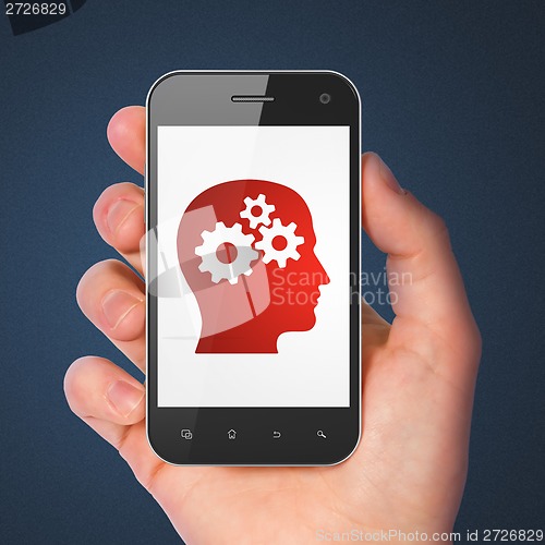 Image of Advertising concept: Head With Gears on smartphone
