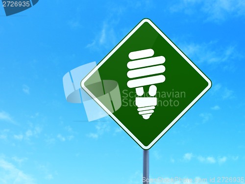 Image of Finance concept: Energy Saving Lamp on road sign background