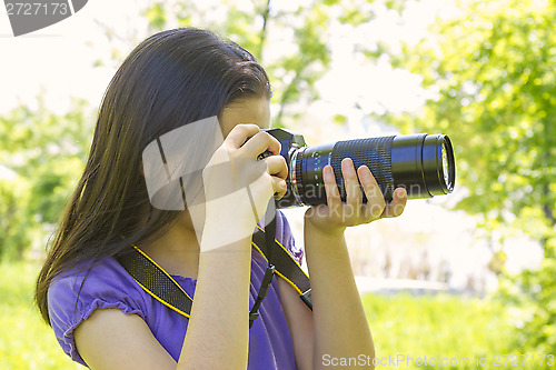 Image of Teenage girl taking photos