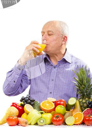 Image of Mature man drinking juice 