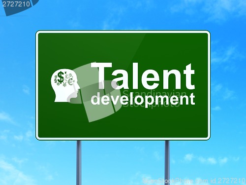 Image of Education concept: Talent Development and Head With Finance Symbol on road sign background