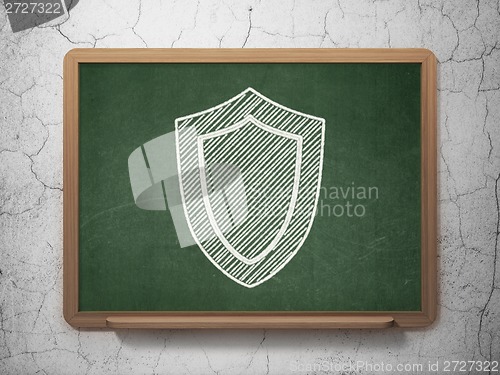 Image of Privacy concept: Shield on chalkboard background