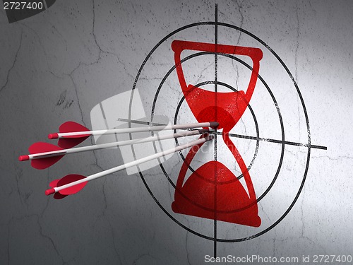 Image of Time concept: arrows in Hourglass target on wall background