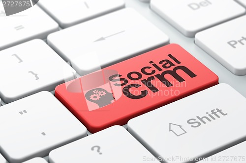 Image of Finance concept: Head With Gears and Social CRM on computer keyboard background