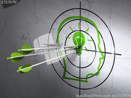 Image of Education concept: arrows in Head With Lightbulb target on wall background