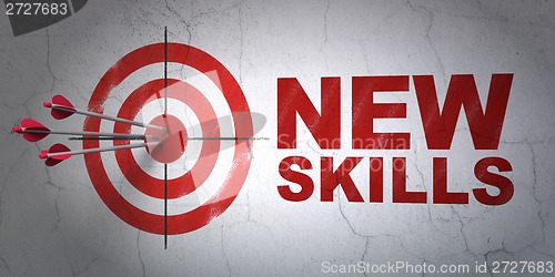 Image of Education concept: target and New Skills on wall background