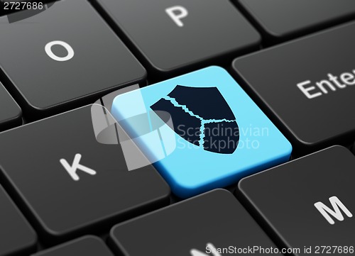 Image of Privacy concept: Broken Shield on computer keyboard background