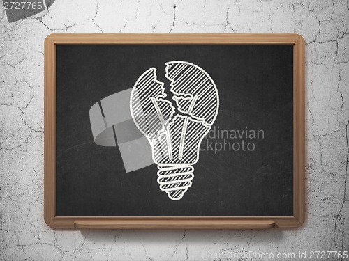 Image of Finance concept: Light Bulb on chalkboard background