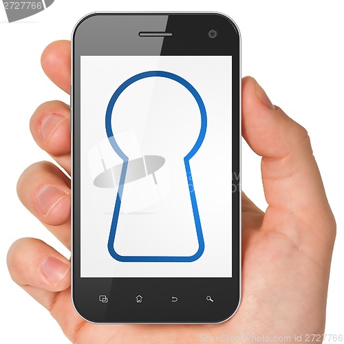 Image of Security concept: Keyhole on smartphone