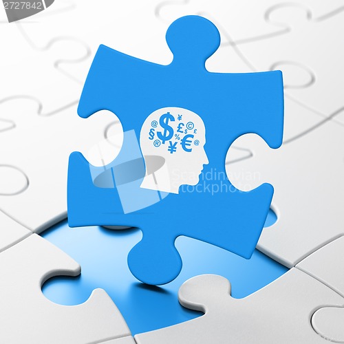 Image of Education concept: Head With Finance Symbol on puzzle background