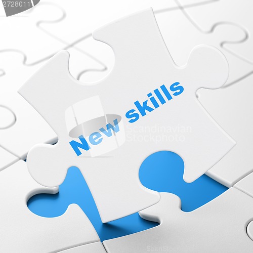 Image of Education concept: New Skills on puzzle background