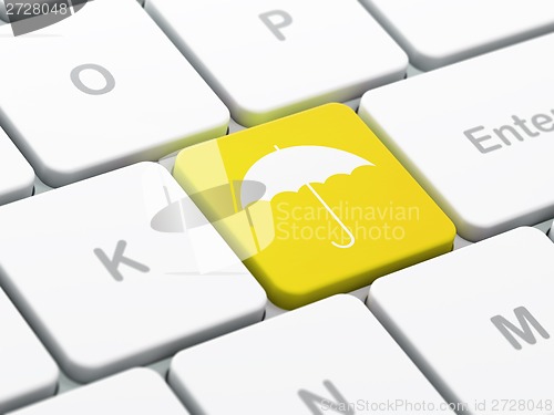 Image of Protection concept: Umbrella on computer keyboard background