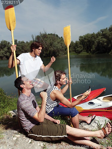 Image of friends having fun near river