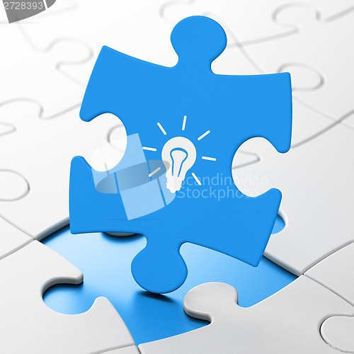 Image of Finance concept: Light Bulb on puzzle background