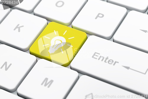 Image of Business concept: Light Bulb on computer keyboard background