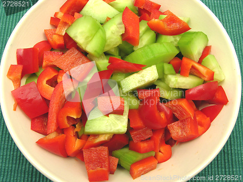 Image of Slices of cucumber and red pepper in a ceramics bowl