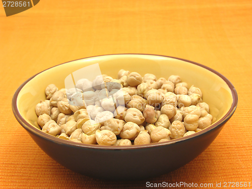 Image of One bowl of ceramic with garbanzos on orange