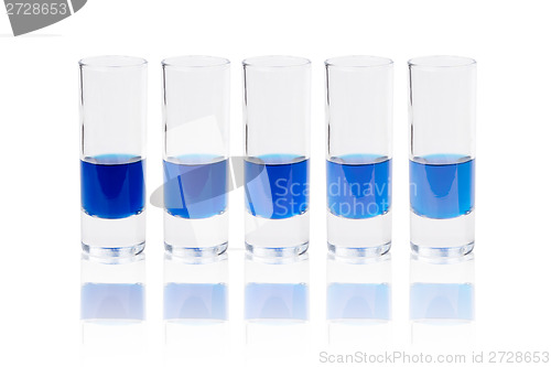 Image of Six glasses with blue liquid
