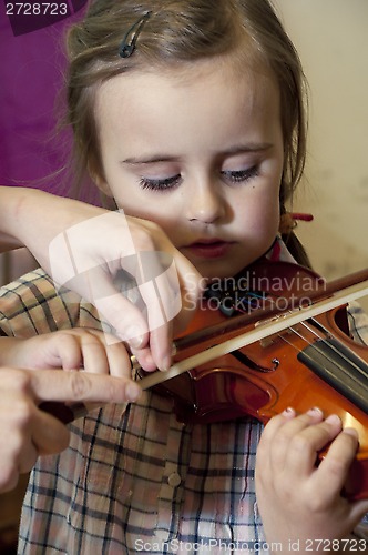 Image of preschool child learning violin playing
