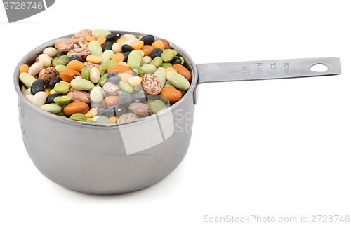 Image of Mixed dried beans in a metal cup measure