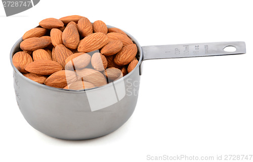 Image of Whole unblanched almonds in a metal cup measure