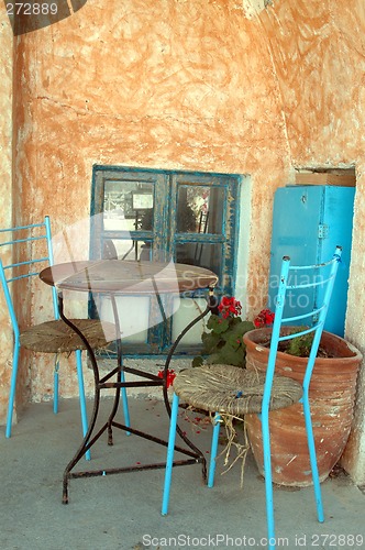 Image of table and colorful old chairs