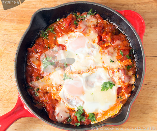 Image of Eggs poached on tomato sauce from above