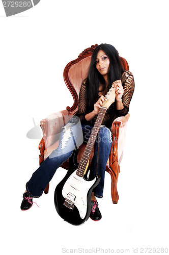 Image of Guitarist sitting in armchair.