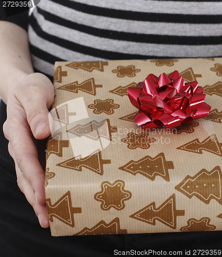 Image of Young woman holding a present