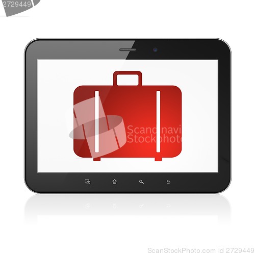 Image of Tourism concept: Bag on tablet pc computer