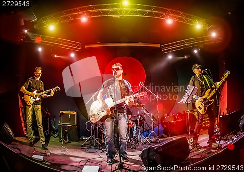 Image of Band performs on stage in a nightclub