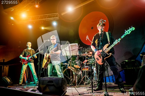 Image of Band performs on stage in a nightclub