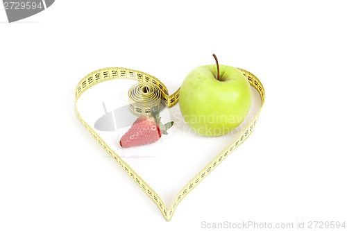 Image of green apple with a measuring tape and heart symbol isolated