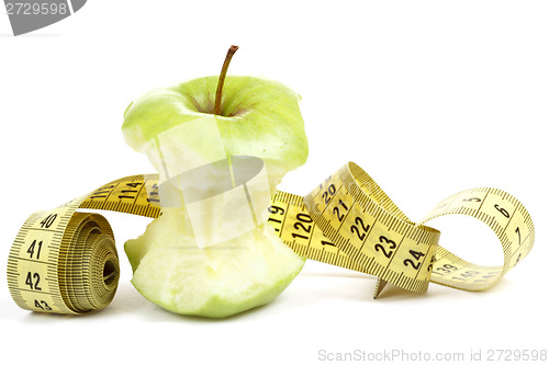 Image of Green bitten apple isolated on white with measuring tape