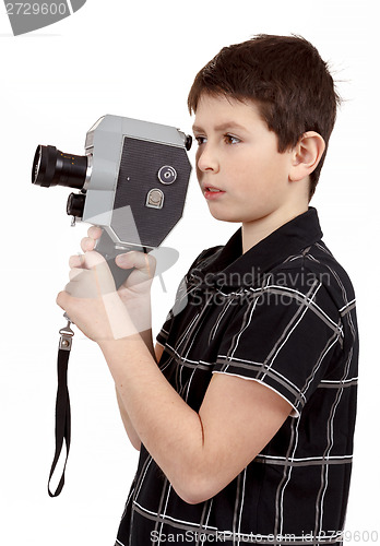 Image of young boy with old vintage analog 8mm camera