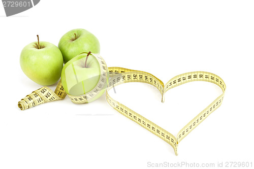 Image of green apple with a measuring tape and heart symbol isolated