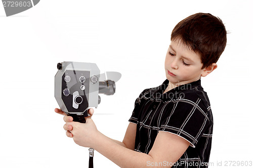 Image of young boy with old vintage analog 8mm camera