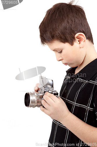 Image of young boy with old vintage analog SLR camera