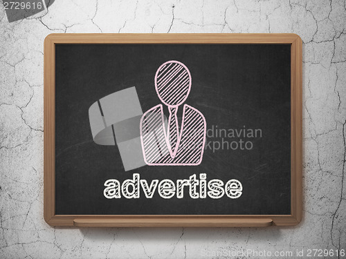 Image of Marketing concept: Business Man and Advertise on chalkboard background