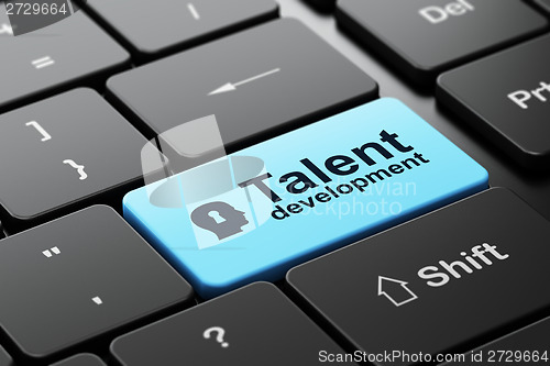 Image of Education concept: Head With Keyhole and Talent Development on computer keyboard background