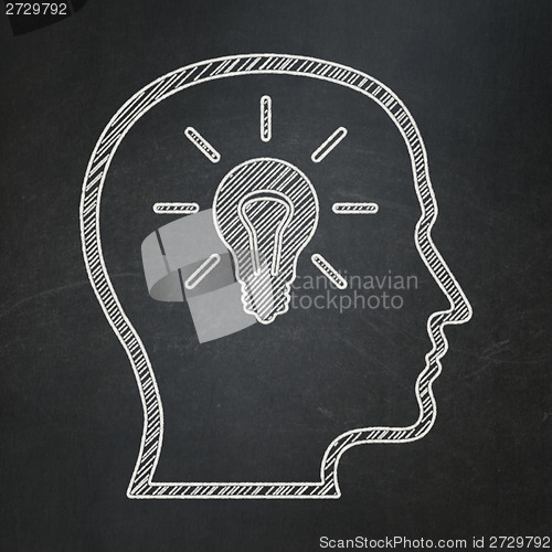 Image of Education concept: Head With Lightbulb on chalkboard background
