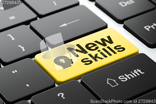 Image of Education concept: Head With Light Bulb and New Skills on computer keyboard background