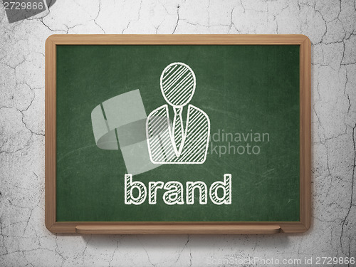 Image of Advertising concept: Business Man and Brand on chalkboard background