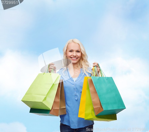 Image of smiling woman with many shopping bags