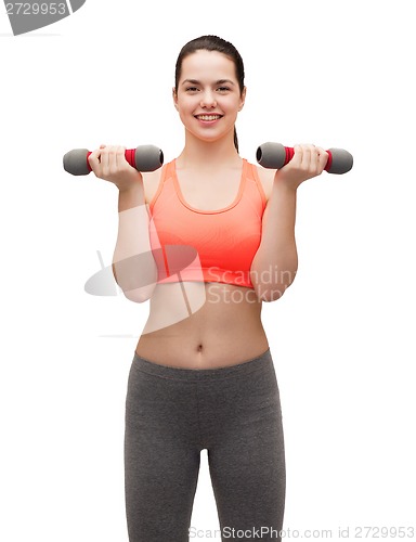 Image of young sporty woman with light dumbbells
