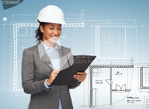 Image of businesswoman in white helmet with clipboard