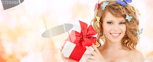 Image of teenager with butterflies in hair showing present