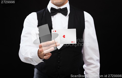 Image of dealer holding white card