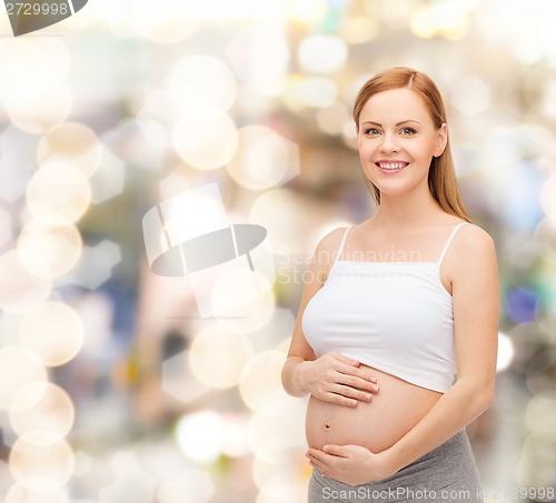 Image of happy future mother touching her belly